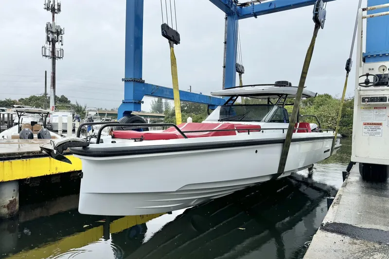 Kraken Yacht Photos Pics 2023 BRABUS Shadow 900 ST boat being lifted by crane at marina.