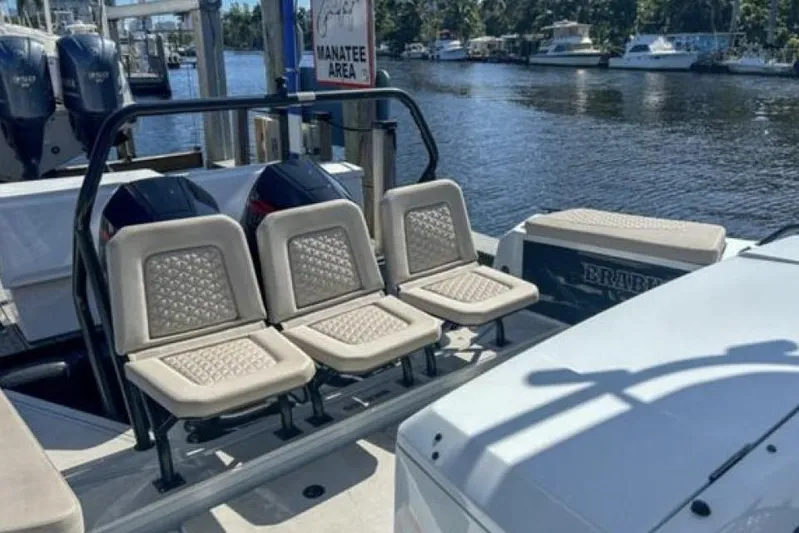 Kraken Yacht Photos Pics 2023 BRABUS Shadow 900 ST boat interior with seating, docked near water.