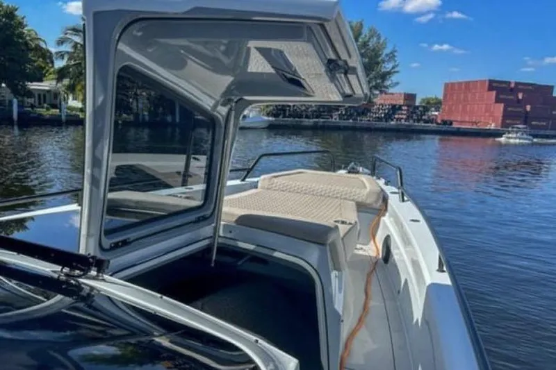 Kraken Yacht Photos Pics 2023 BRABUS Shadow 900 ST boat on a sunny waterfront, showcasing open cabin and sleek design.