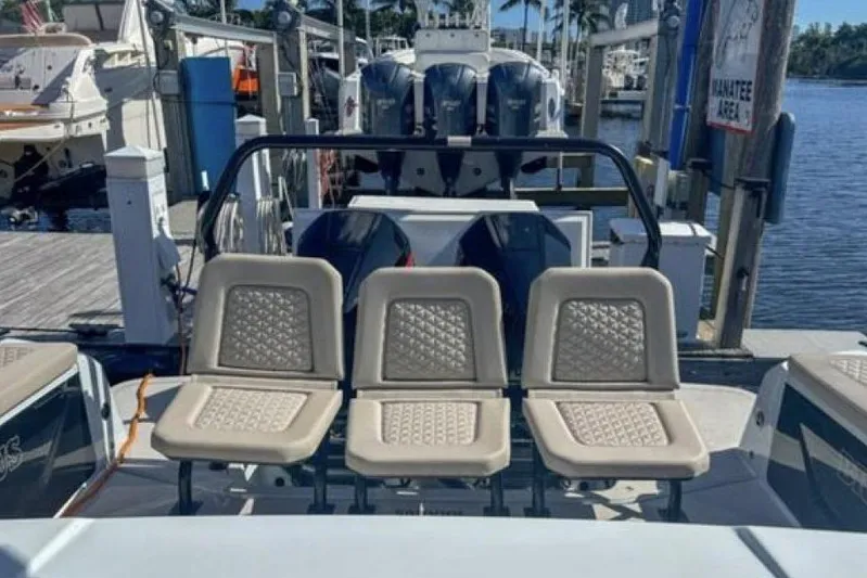 Kraken Yacht Photos Pics 2023 BRABUS Shadow 900 ST boat with three beige seats at a marina.