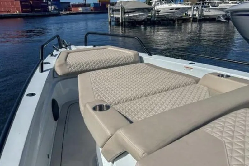 Kraken Yacht Photos Pics 2023 BRABUS Shadow 900 ST boat with luxurious seating at a marina.