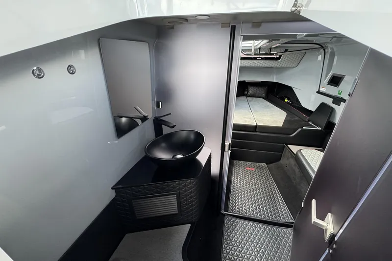 Kraken Yacht Photos Pics Luxurious interior of 2023 BRABUS Shadow 900 ST with modern sink and seating area.