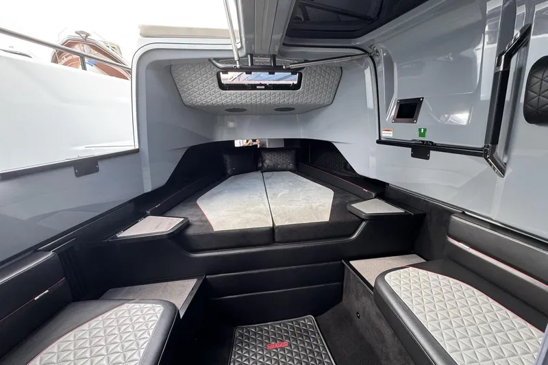 Kraken Yacht Photos Pics Luxurious interior of 2023 BRABUS Shadow 900 ST boat with quilted seating and modern design.