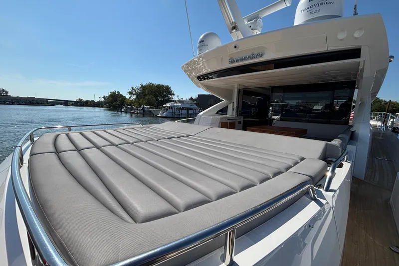  Yacht Photos Pics 2018 Sunseeker Predator 74 yacht with spacious sunbed and sleek design on a sunny day.