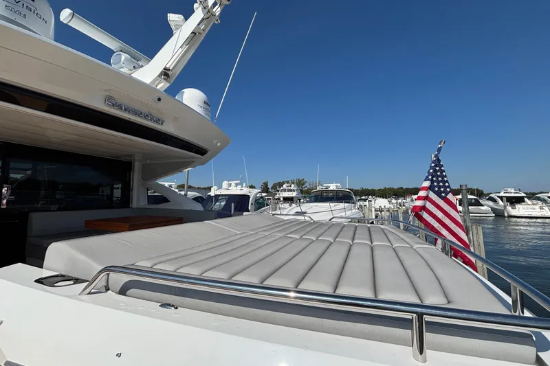  Yacht Photos Pics 2018 Sunseeker Predator 74 yacht docked, featuring sleek design and American flag.