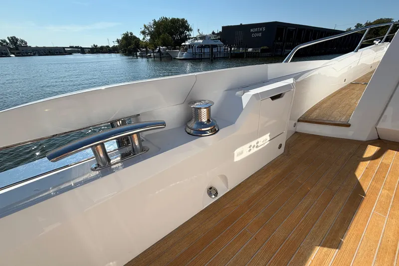  Yacht Photos Pics 2018 Sunseeker Predator 74 yacht deck with sleek railing and waterfront view.
