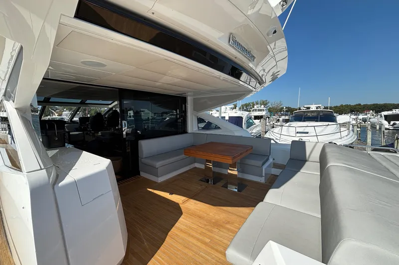  Yacht Photos Pics 2018 Sunseeker Predator 74 yacht with spacious outdoor seating and wooden deck.