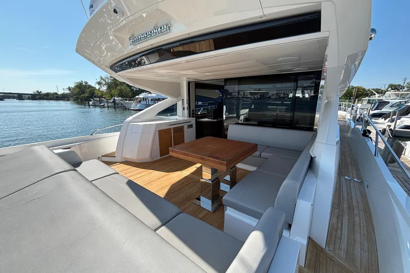  Yacht Photos Pics Luxurious 2018 Sunseeker Predator 74 yacht with spacious outdoor seating and dining area.