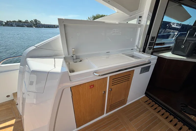  Yacht Photos Pics Outdoor kitchenette on 2018 Sunseeker Predator 74 yacht, featuring sink and storage cabinets.