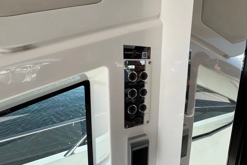  Yacht Photos Pics Control panel on 2018 Sunseeker Predator 74 yacht, featuring various switches and buttons.