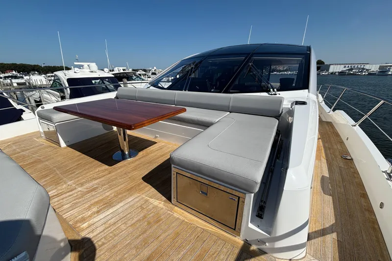 Yacht Photos Pics 2018 Sunseeker Predator 74 yacht deck with seating and wooden table.
