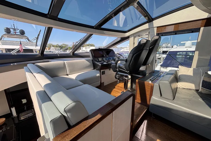  Yacht Photos Pics Luxurious interior of 2018 Sunseeker Predator 74 yacht with modern seating and helm.