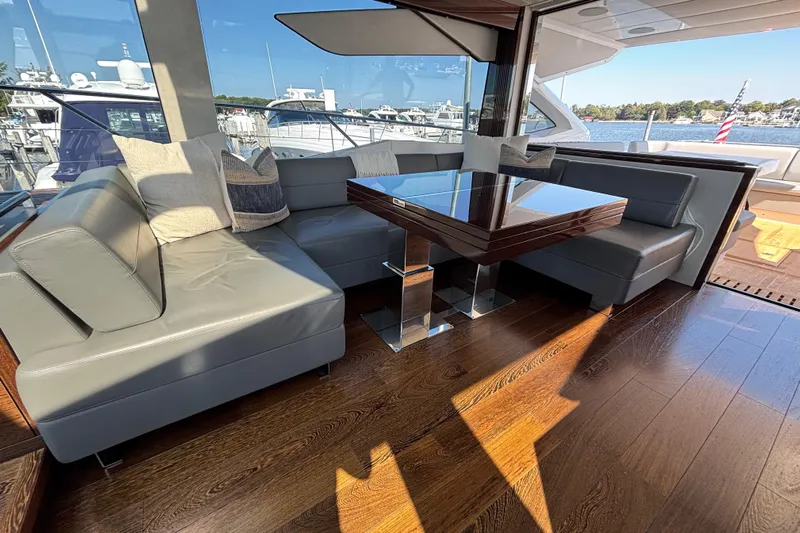 Yacht Photos Pics Luxurious interior of 2018 Sunseeker Predator 74 yacht with elegant seating and wooden flooring.