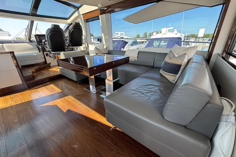  Yacht Photos Pics Luxurious interior of 2018 Sunseeker Predator 74 yacht with leather seating and wooden flooring.