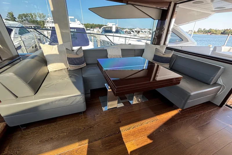  Yacht Photos Pics Luxurious interior of 2018 Sunseeker Predator 74 yacht with elegant seating and table.