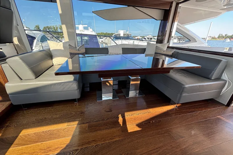  Yacht Photos Pics Luxurious interior of 2018 Sunseeker Predator 74 yacht with sleek seating and elegant table.