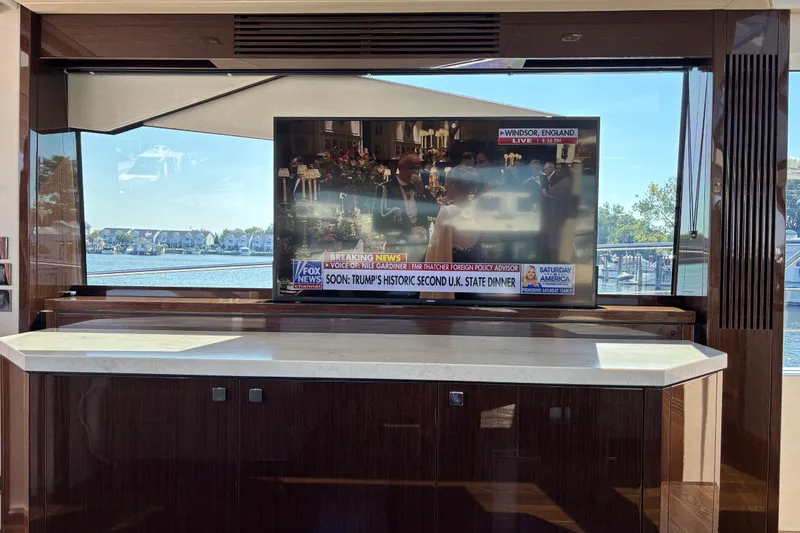  Yacht Photos Pics Luxurious interior of 2018 Sunseeker Predator 74 yacht with TV and scenic window view.