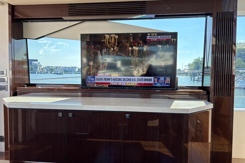  Yacht Photos Pics Interior of 2018 Sunseeker Predator 74 yacht with TV and waterfront view.