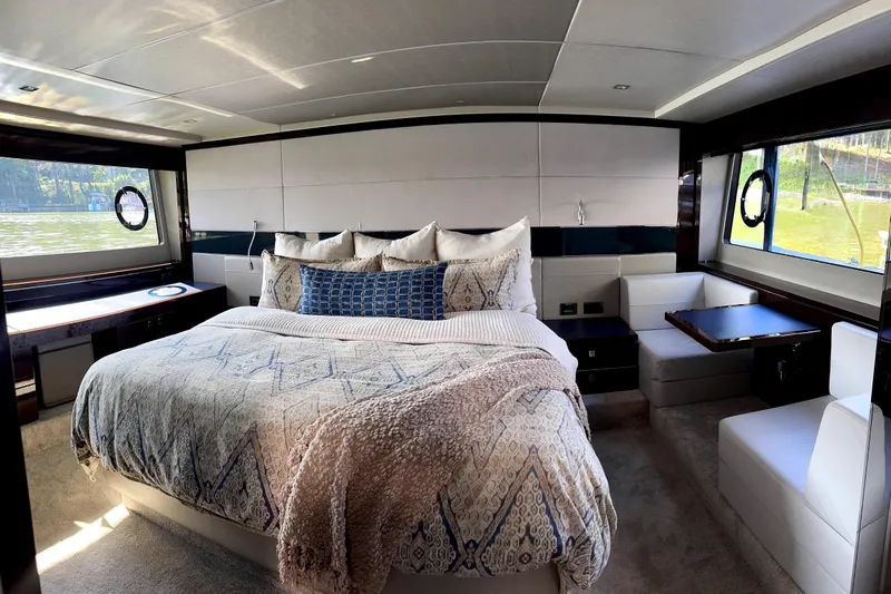  Yacht Photos Pics Luxurious bedroom interior of 2018 Sunseeker Predator 74 yacht with elegant bedding.