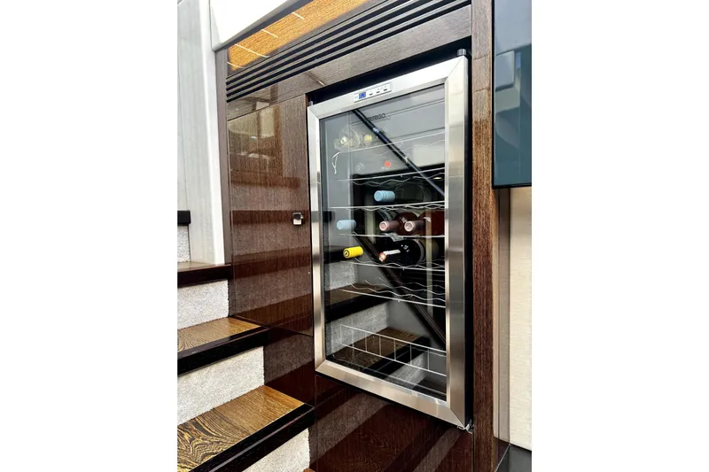  Yacht Photos Pics Wine cooler on Sunseeker Predator 74 yacht, 2018 model, near wooden staircase.