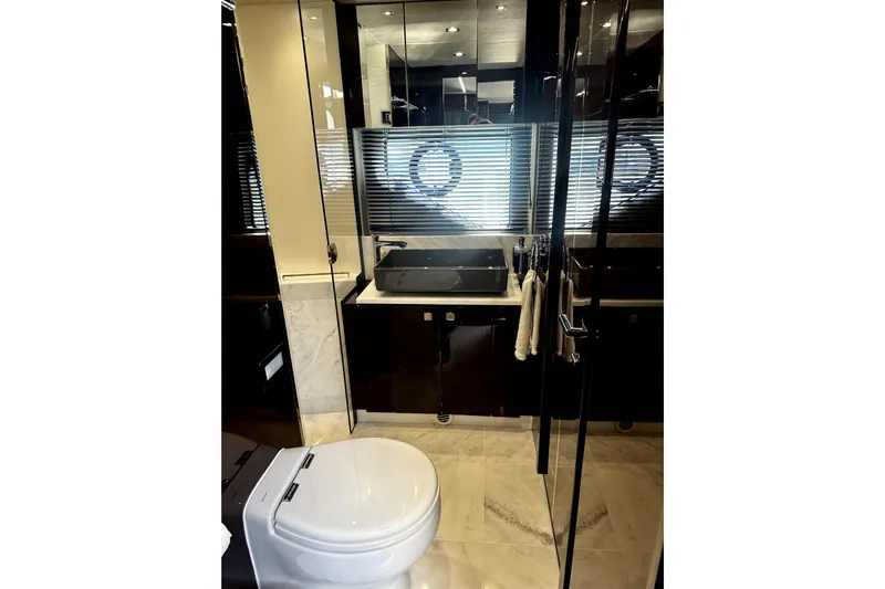  Yacht Photos Pics Luxurious bathroom in 2018 Sunseeker Predator 74 yacht with modern fixtures and elegant design.