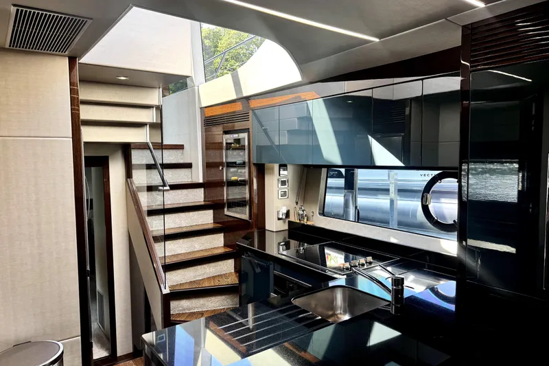  Yacht Photos Pics Luxurious interior of 2018 Sunseeker Predator 74 yacht with modern kitchen and staircase.