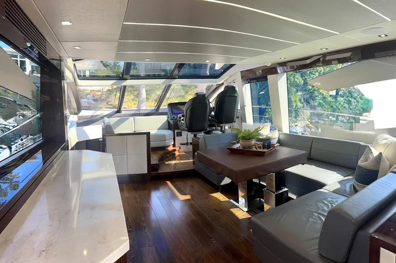  Yacht Photos Pics Luxurious interior of 2018 Sunseeker Predator 74 yacht with modern furnishings and panoramic windows.