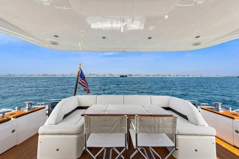 La-z-buoy Yacht Photos Pics Luxurious 2015 Princess 72 Motor Yacht deck with seating, ocean view, and American flag.