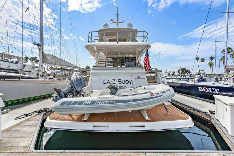 La-z-buoy Yacht Photos Pics 2015 Princess 72 Motor Yacht docked with tender boat, marina background, clear sky.