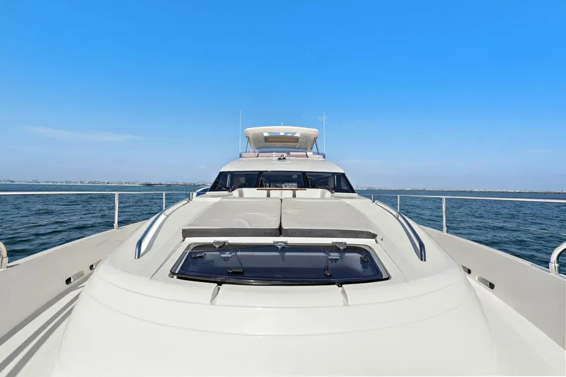 La-z-buoy Yacht Photos Pics 2015 Princess 72 Motor Yacht cruising on open water under clear blue sky.