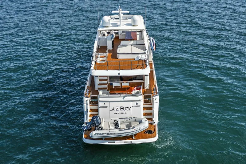 La-z-buoy Yacht Photos Pics 2015 Princess 72 Motor Yacht on open water, rear view, with tender boat attached.