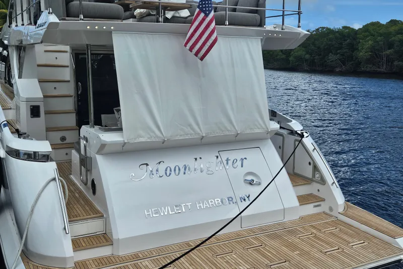  Yacht Photos Pics Azimut 66 yacht, 2022 model, docked with American flag, named "Moonlighter."