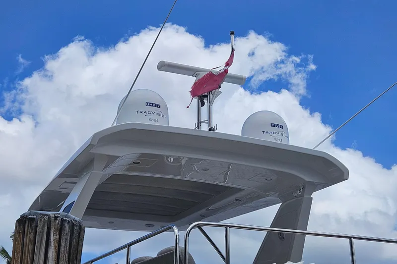  Yacht Photos Pics Azimut 66 yacht, 2022 model, featuring TracVision satellite domes against a blue sky.