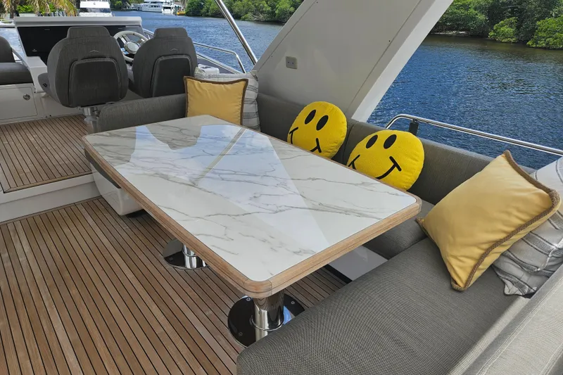  Yacht Photos Pics Luxurious Azimut 66 yacht interior with marble table, smiley cushions, and river view.