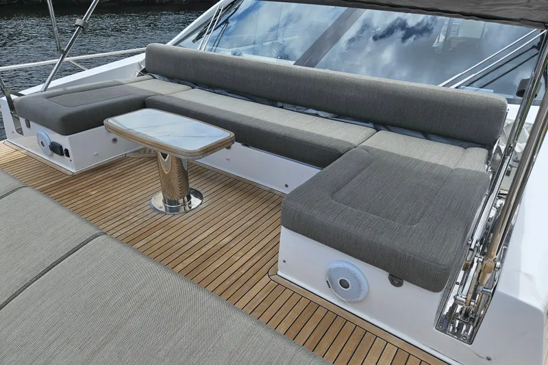  Yacht Photos Pics Luxurious seating area on 2022 Azimut 66 yacht with teak flooring and modern design.