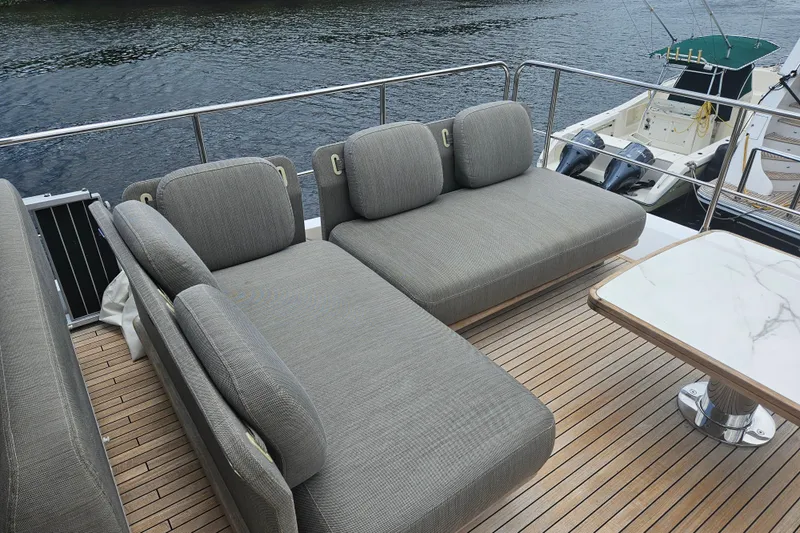  Yacht Photos Pics Luxurious seating area on 2022 Azimut 66 yacht with elegant wooden deck.