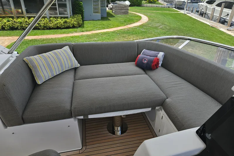  Yacht Photos Pics Luxurious seating area on 2022 Azimut 66 yacht with gray cushions and decorative pillows.