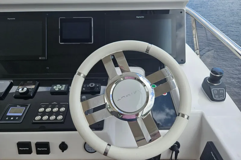  Yacht Photos Pics Steering wheel and controls of 2022 Azimut 66 yacht, featuring advanced navigation systems.