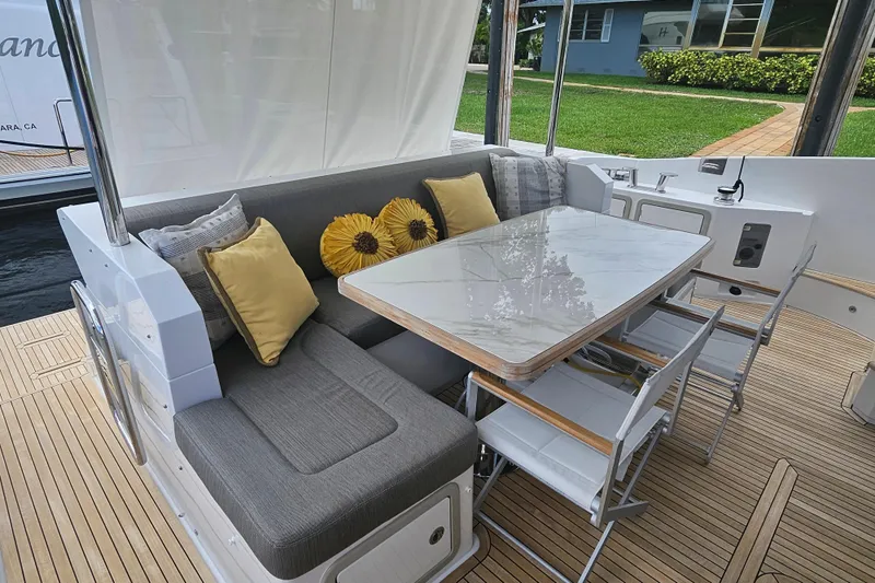  Yacht Photos Pics Luxurious seating area on 2022 Azimut 66 yacht with elegant cushions and table.