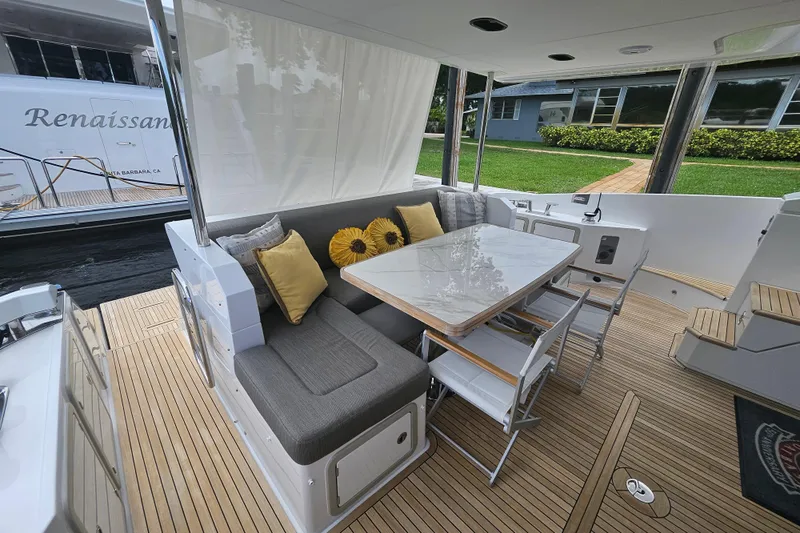  Yacht Photos Pics Luxurious 2022 Azimut 66 yacht deck with elegant seating and dining area.