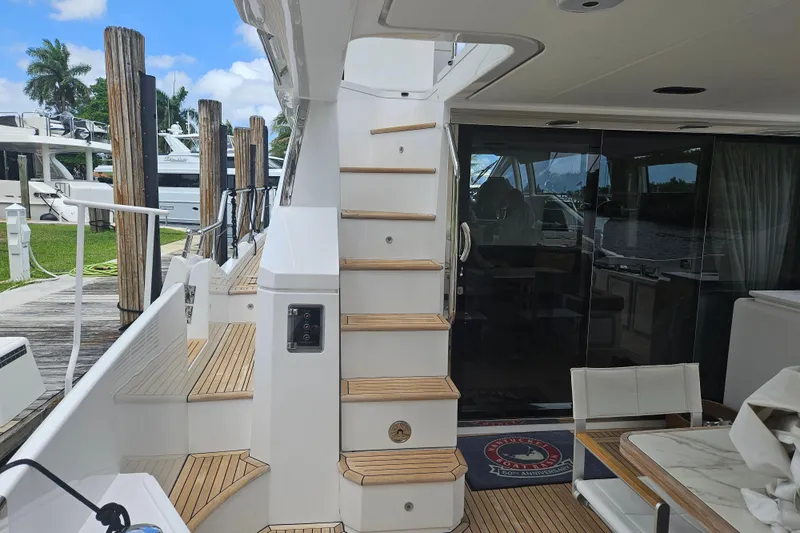  Yacht Photos Pics Azimut 66 yacht interior, 2022 model, featuring elegant wooden stairs and modern design.