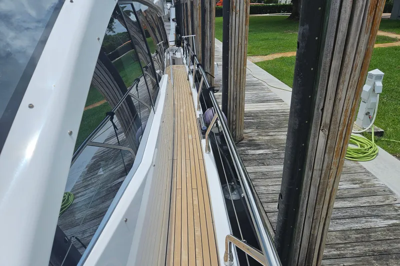  Yacht Photos Pics 2022 Azimut 66 yacht docked, showcasing sleek design and wooden deck.