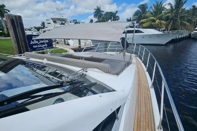  Yacht Photos Pics 2022 Azimut 66 yacht with sleek design, docked near palm trees and waterway.