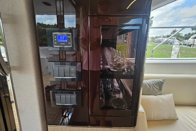  Yacht Photos Pics Luxurious interior of 2022 Azimut 66 yacht featuring control panel and glassware display.