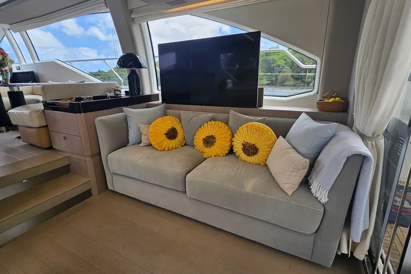 Yacht Photos Pics Luxurious Azimut 66 yacht interior with cozy sofa, sunflower pillows, and scenic window view.