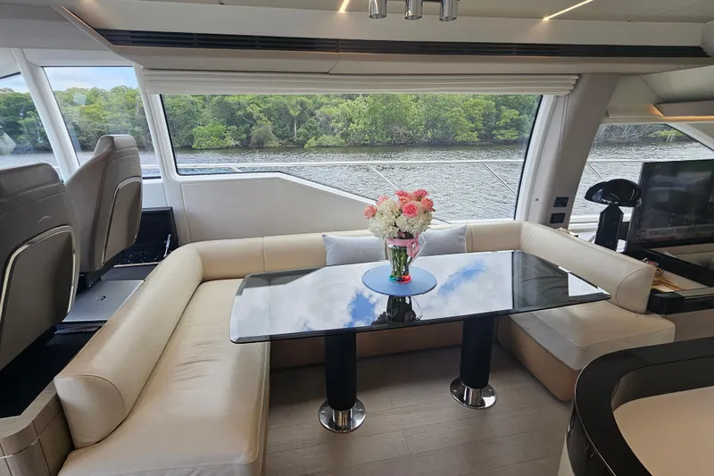  Yacht Photos Pics Luxurious interior of 2022 Azimut 66 yacht with elegant seating and scenic window view.