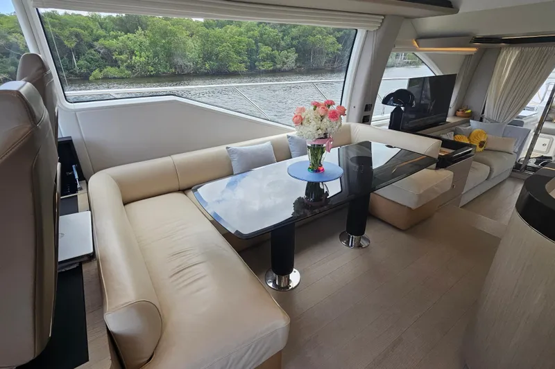  Yacht Photos Pics Luxurious interior of 2022 Azimut 66 yacht with elegant seating and scenic window view.