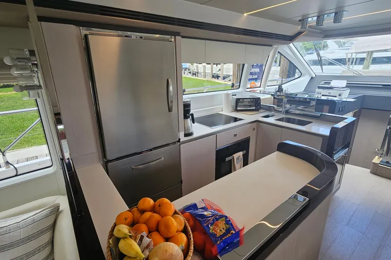  Yacht Photos Pics Luxurious 2022 Azimut 66 yacht kitchen with modern appliances and fruit basket.