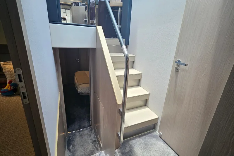  Yacht Photos Pics Interior staircase of 2022 Azimut 66 yacht, featuring modern design and sleek finishes.