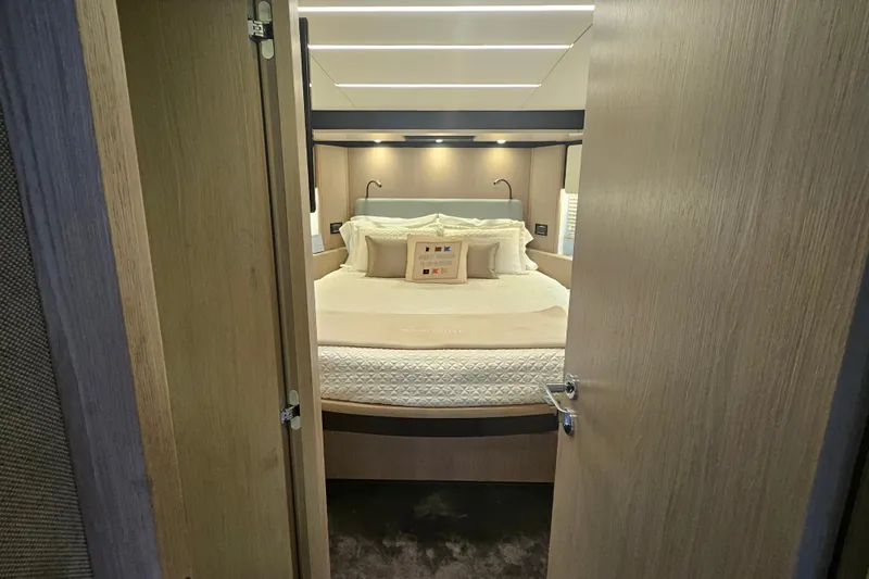  Yacht Photos Pics Luxurious bedroom interior of 2022 Azimut 66 yacht with elegant bedding and modern lighting.